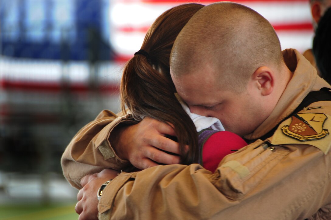 Capt. Allen Ferkovich, 37th Bomb Squadron weapon systems officer instructor from Ellsworth Air Force Base, S.D., shares one last hug with his wife before leaving for Southwest Asia, Jan. 15, 2011.  Approximately 300 Airmen deployed in support of overseas contingency operations. (U.S. Air Force photo/Senior Airman Anthony Sanchelli)
