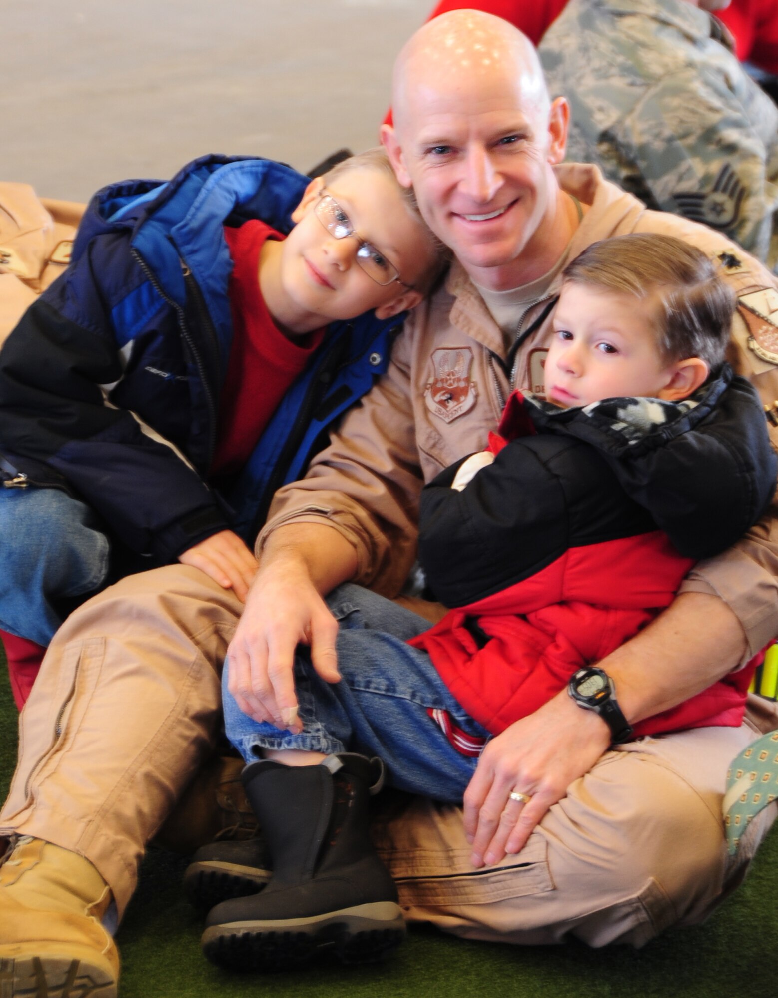Lt. Col.  Derek Leivestad, 37th Bomb Squadron instructor pilot from Ellsworth Air Force Base, S.D., waits with his two sons before setting out on a deployment to Southwest Asia, Jan. 15, 2011.  Approximately 300 Airmen deployed in support of overseas contingency operations. (U.S. Air Force photo/Senior Airman Anthony Sanchelli)
