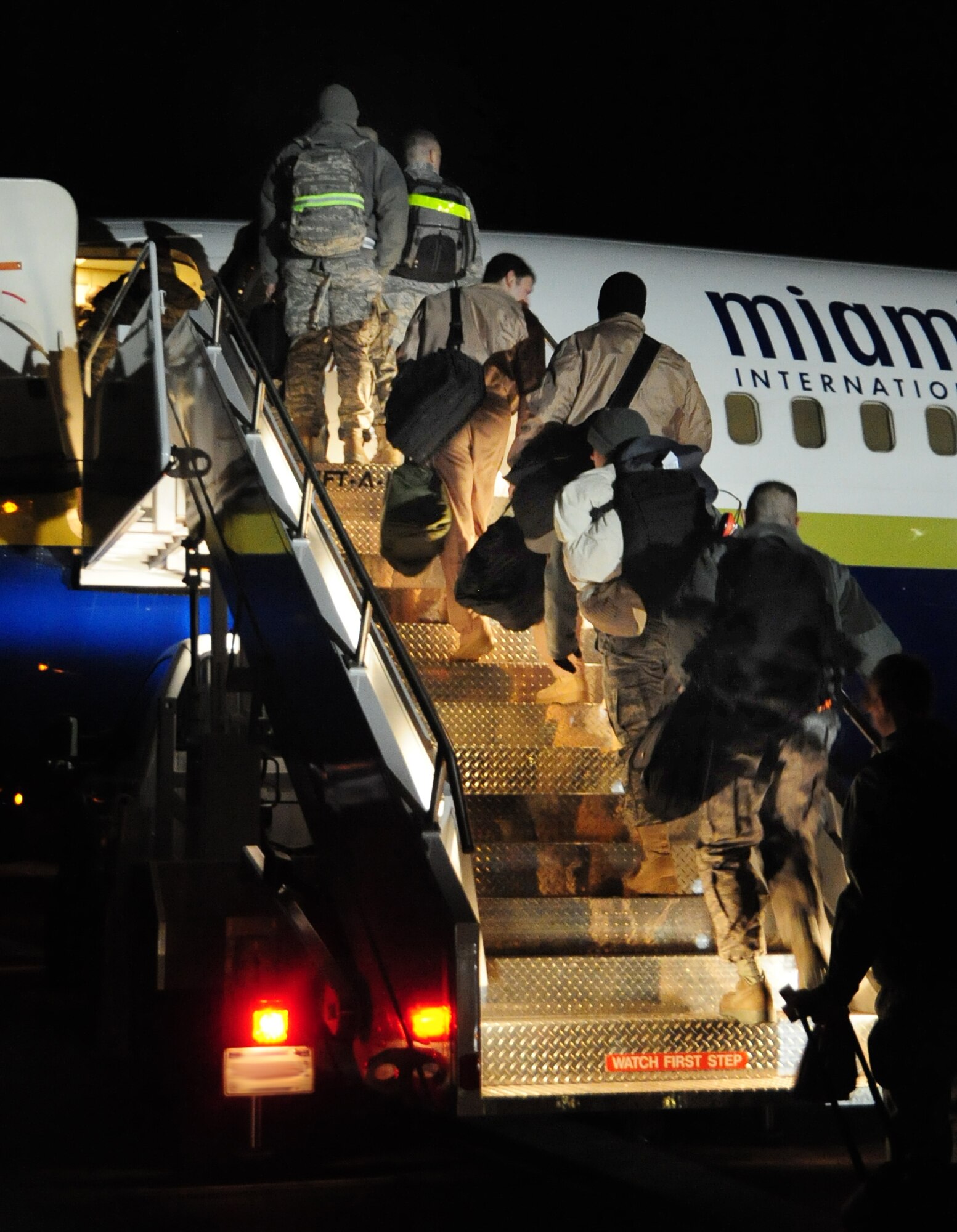 Airmen board an aircraft at Ellsworth Air Force Base, S.D. on Jan. 12, 2011, on their way to Southwest Asia.  A small group of Ellsworth Airmen left on a deployment to Southwest Asia in advance of approximately 300 Airmen deployed on Jan. 15, 2011. (U.S. Air Force Photo/Senior Airman Anthony Sanchelli)

