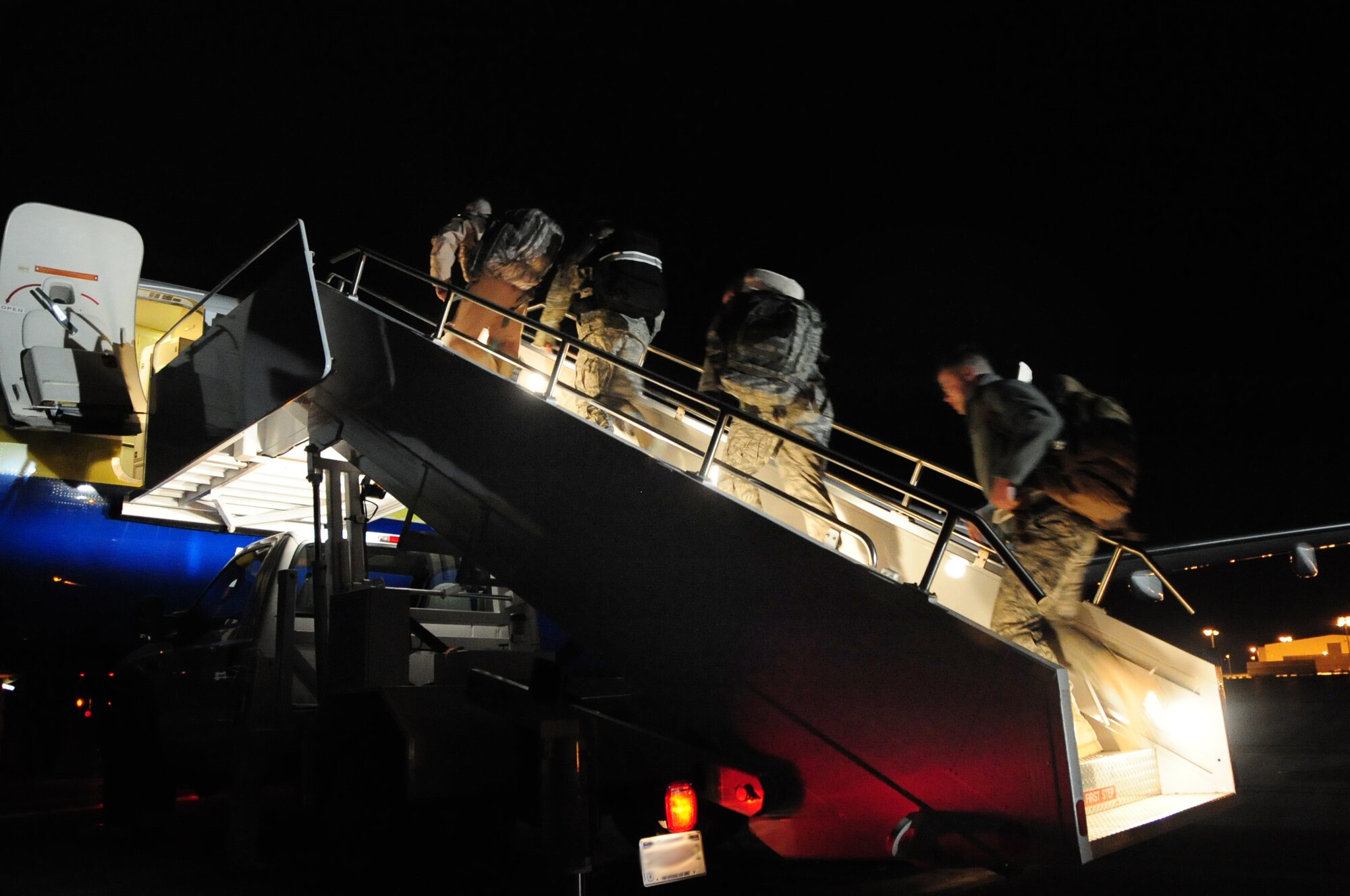 Airmen board an aircraft at Ellsworth Air Force Base, S.D. on Jan. 12, 2011, on their way to Southwest Asia.  A small group of Ellsworth Airmen left on a deployment to Southwest Asia in advance of approximately 300 Airmen deployed on Jan. 15, 2011. (U.S. Air Force Photo/Senior Airman Anthony Sanchelli)
