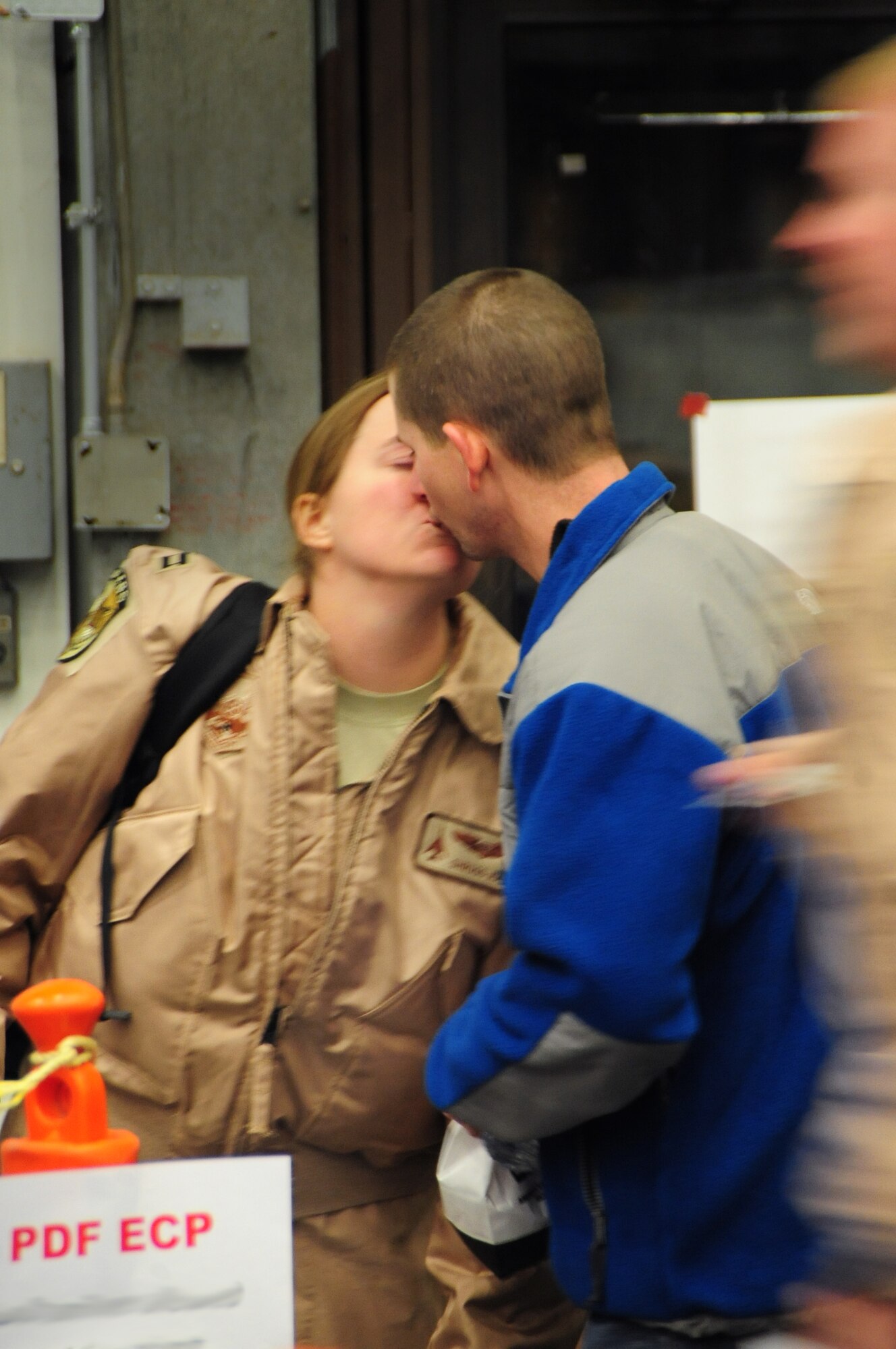 Capt. Tara Hart, 37th Bomb Squadron instructor weapon systems officer, gives her husband one last kiss before processing through a deployment line at Ellsworth Air Force Base, S.D. on Jan. 12, 2011.  Capt. Hart was part of a small cadre that deployed in advance of a larger group of Airmen that deployed in support of overseas contingency operations on Jan. 15, 2011. (U.S. Air Force Photo/Senior Airman Anthony Sanchelli)
