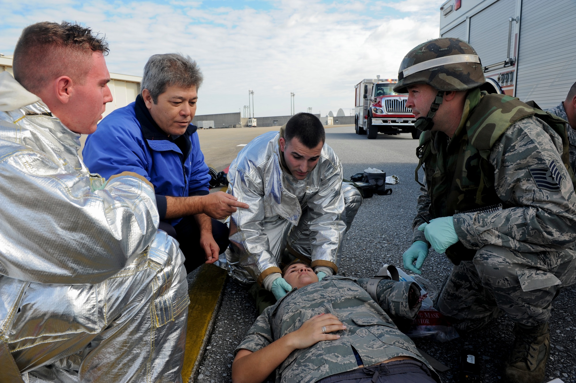 Firefighters from the 18th Civil Engineer Squadron treat a simulated victim from a simulated E-3 Sentry engine fire Jan. 19. The simulated engine fire was part of Beverly High 11-02, a local operational readiness exercise, and tested the fire department’s ability to respond to an aircraft fire. (U.S. Air Force photo/Staff Sgt. Jonathan Steffen)