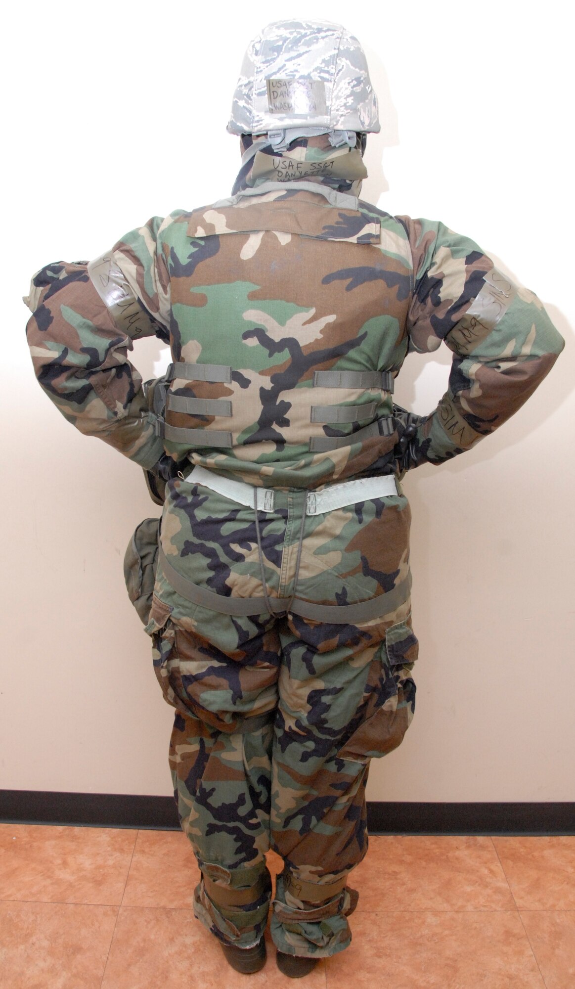 KUNSAN AIR BASE, Republic of Korea -- Staff Sgt. Danyette Washington, 8th Civil Engineer Squadron readiness and emergency management technician, shows proper wear of Mission-Oriented Protective Posture gear. The gloves are under the sleeves, sleeves are secure, simulated M-9 tape is between the straps on the bottom of the pants, pants are secure over the boots, M-9 tape is placed on sleeves and wrists, and the back Velcro and retention cord are secure. (U.S. Air Force photo/Staff Sgt. Amanda Savannah)