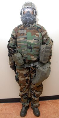 KUNSAN AIR BASE, Republic of Korea -- Staff Sgt. Danyette Washington, 8th Civil Engineer Squadron readiness and emergency management technician, shows proper wear of Mission-Oriented Protective Posture gear. MOPP 4 correctly. The mask carrier is closed, gloves are under the sleeves, sleeves are secure, simulated M-9 tape is between the straps on the bottom of the pants, pants are secure over the boots, M-9 tape is placed on sleeves and wrists, and the Velcro and retention cord are secure. (U.S. Air Force photo/Staff Sgt. Amanda Savannah)