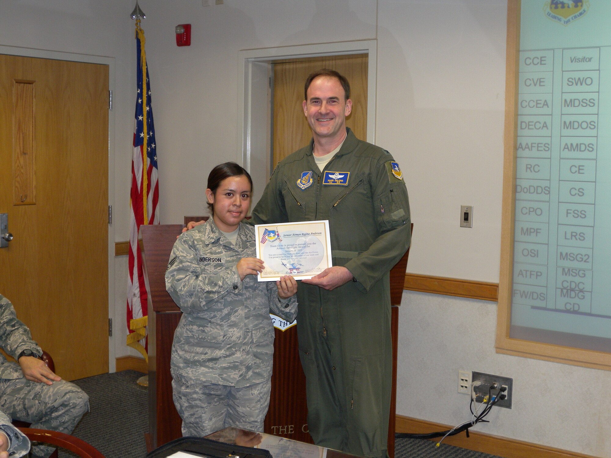 Senior Airman Regina Anderson, 51st Communications Squadron, left, receives her Airman Spotlight certificate from Col. Mark DeLong, 51st Fighter Wing vice commander, Jan. 18 (U.S. Air Force photo/Capt. Matthew Stines)