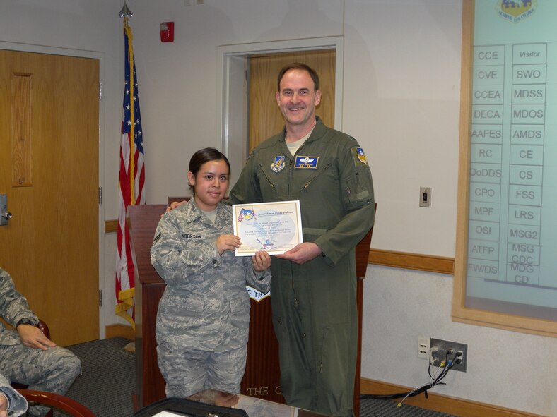 Senior Airman Regina Anderson, 51st Communications Squadron, left, receives her Airman Spotlight certificate from Col. Mark DeLong, 51st Fighter Wing vice commander, Jan. 18 (U.S. Air Force photo/Capt. Matthew Stines)