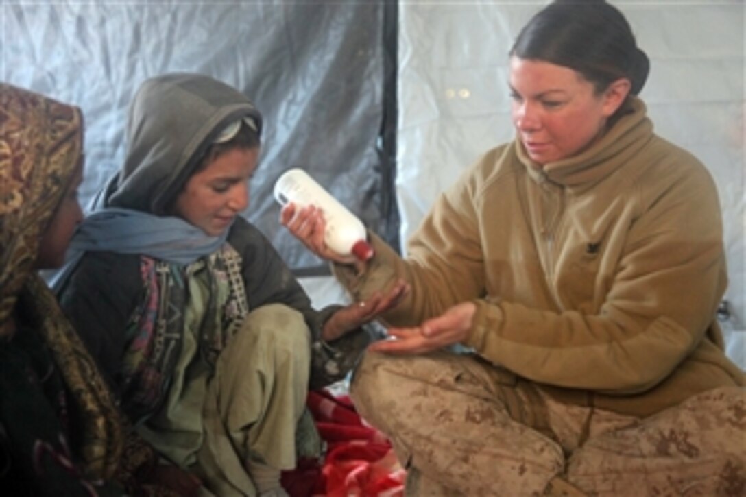 U.S. Navy Petty Officer 3rd Class Heidi A. Dean (right), with the female engagement team attached to 3rd Battalion, 5th Marine Regiment, Regimental Combat Team 2, gives a basic hygiene class during a health initiative in Sangin, Helmand province, Afghanistan, on Jan. 4, 2011.  The health initiative was conducted to train local health care providers, treat the sick and injured and enhance Afghan National Security Force relations with the local population.  