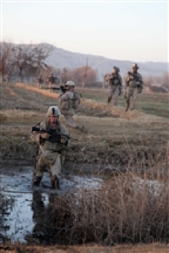 U.S. Marines with 1st Platoon, Kilo Company, 3rd Battalion, 5th Marine Regiment cross a canal during a security patrol in Sangin, Afghanistan, on Jan. 8, 2011.  Marines conducted counterinsurgency operations with the International Security Assistance Force to suppress insurgent activity and gain the trust of Afghan citizens.  