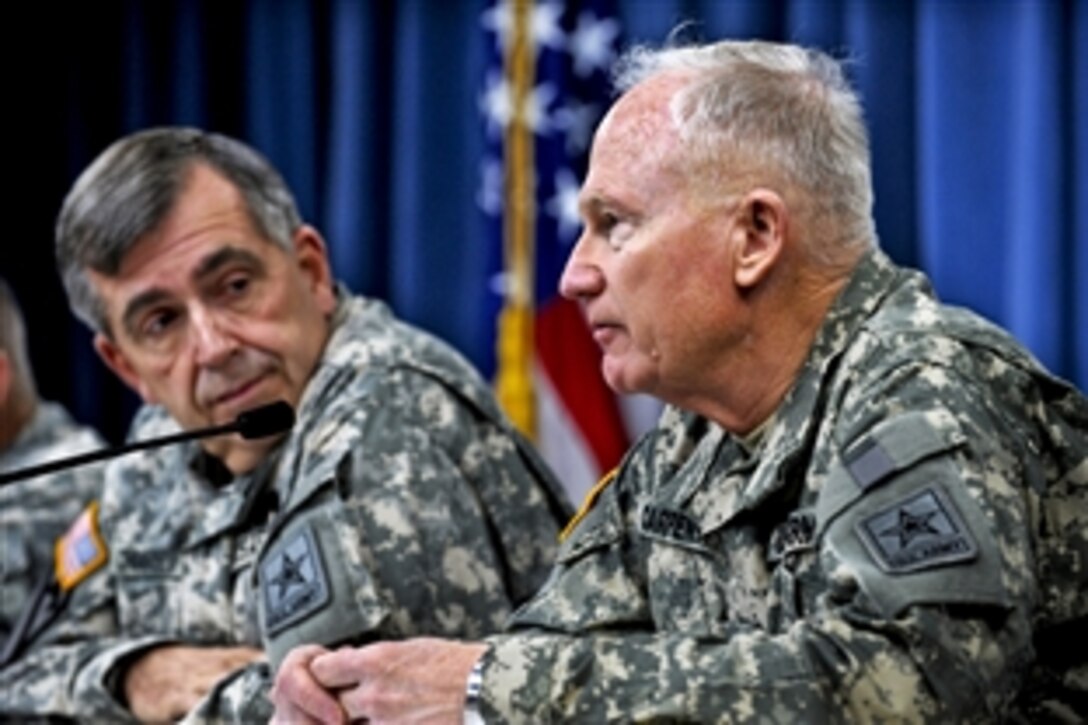 Army Vice Chief of Staff Gen. Peter W. Chiarelli, left, listens as Army National Guard Acting Director Maj. Gen. Raymond W. Carpenter discusses the Army's newly released suicide statistics for last year during a press conference at the Pentagon, Jan. 19, 2011. 2010.