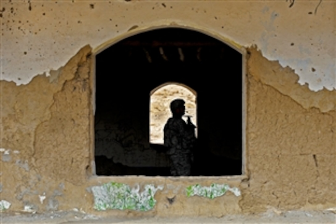 U.S. Army Sgt. 1st Class Jeffrey Cesaitis walks through an abandoned building in the Shahr-e Safa bazaar during a site assessment in Afghanistan, Jan. 19, 2011. Members of Provincial Reconstruction Team Zabul visited the bazaar to assess future projects and speak to elders about village issues.