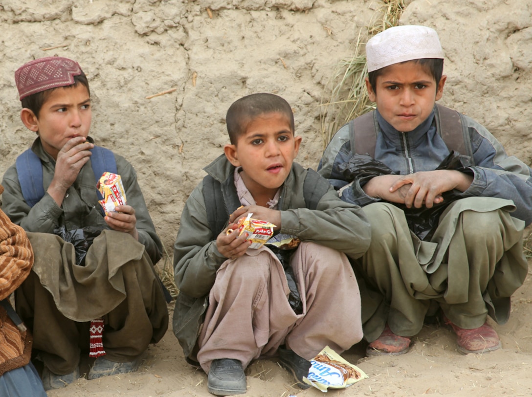 Afghan children enjoy their snacks after Marines and sailors with Delta Company, 3rd Light Armored Reconnaissance Battalion, 1st Marine Division (Forward), gave them a class on proper hygiene techniques at their school, Jan. 19, 2011. The Marines and sailors also gave the children hygiene products like soap and toothpaste.