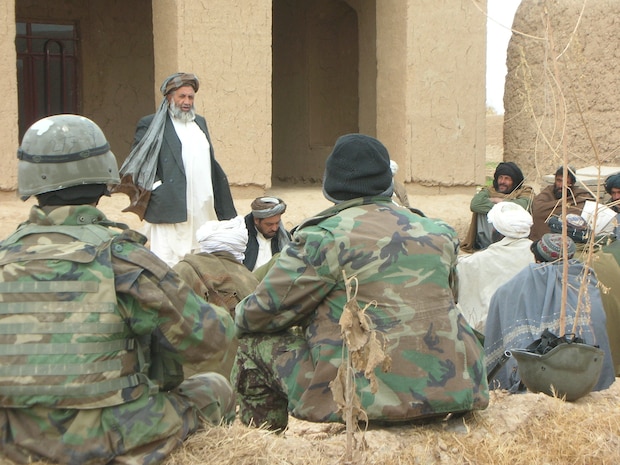 Haji Abdul Manaf, the district governor of Nawa, addresses a crowd of elders during a shura, in Trek Nawa, Helmand province, Afghanistan, Jan. 19. Trek Nawa, a relatively ungoverned region between the Marjah and Nawa districts, is home to approximately 200 families from three Pashtun clans, the Alizai, Hasanzai and Barakzai. Few families officially own land there, and the region is loosely monitored in comparison to nearby districts. Coalition officials consider Trek Nawa a hideout for Taliban who have been driven out of Marjah and Nawa over the past year. However, for the first time, one clan from Trek Nawa expressed willingness to support several coalition initiatives, including the eradication of poppy and taking up arms against the Taliban. However, their tentative support is contingent upon support from local security forces.
