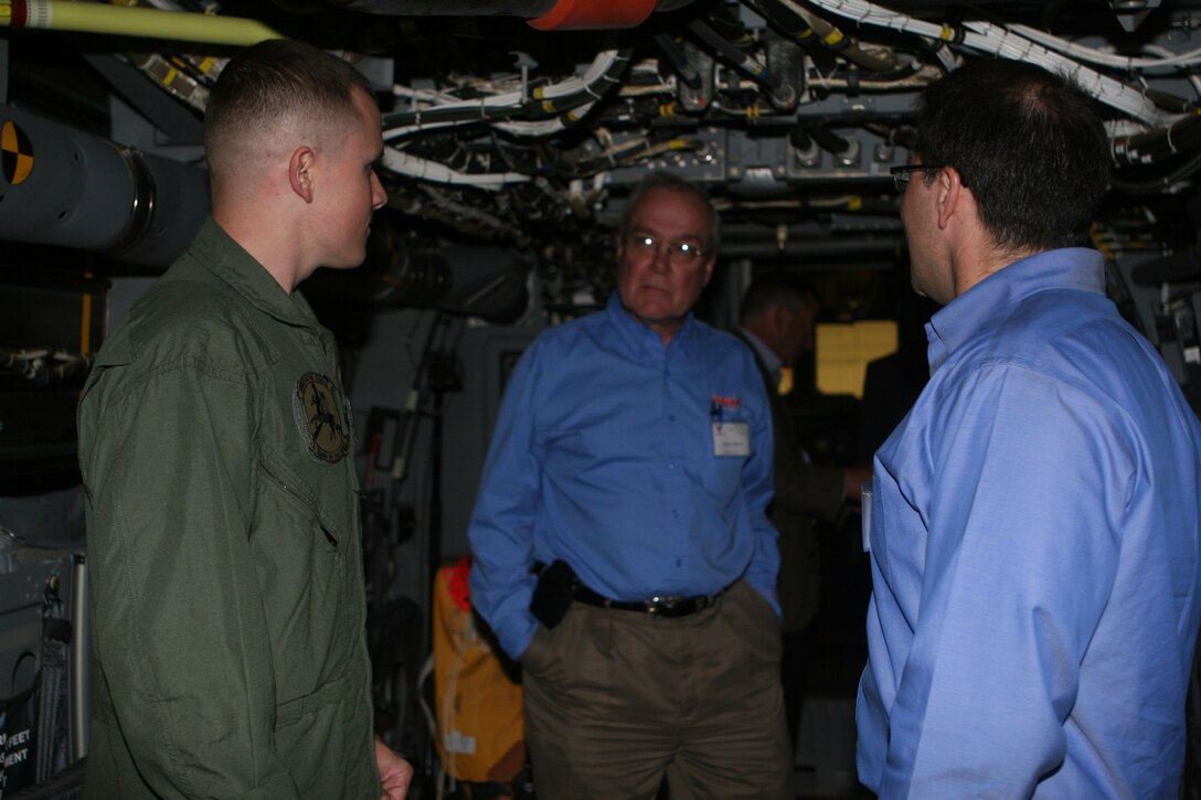 Sgt. Brandon Boesch, a crew chief with Marine Medium Tiltrotor Squadron 161, speaks with Jim Meyers and Robert Hatfield, both members of "Team Osprey," about the MV-22 "Osprey" helicopter aboard Marine Corps Air Station Miramar Jan. 19. Team Osprey is a group of representatives from the military and industry that meet regularly to discuss the V-22 Program.