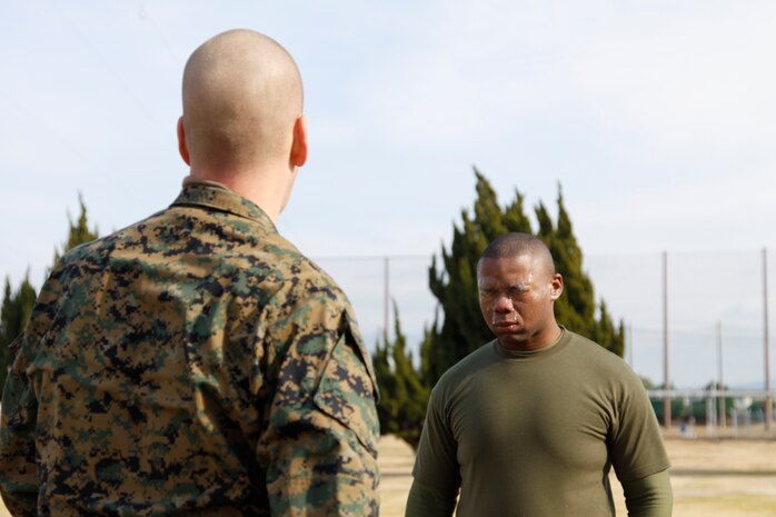 Lance Cpl. Kenneth K. Trotter Jr., a station combat correspondent, struggles to count the fingers in front of him after being sprayed in the face with Oleoresin Capsicum spray during an OC course at the Provost Marshal’s Office here Jan. 20. The training noncommissioned-officer who sprayed the service members in the face with OC forced them to count his fingers to ensure the liquid took effect.