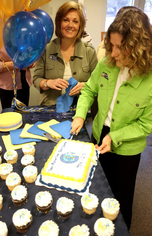 Gini Schopfel (right), director of the Navy – Marine Corps Relief Services branch aboard Marine Corps Base Camp Lejeune, and Kelly Shortt, a support relief services assistant with the NMCRS, cut the birthday cake of the society’s 107th birthday celebration Jan. 20. In addition to commemorating history and traditions of the program, employees and volunteers alike celebrated reaching a milestone of providing more than $3 million in financial assistance in 2010.