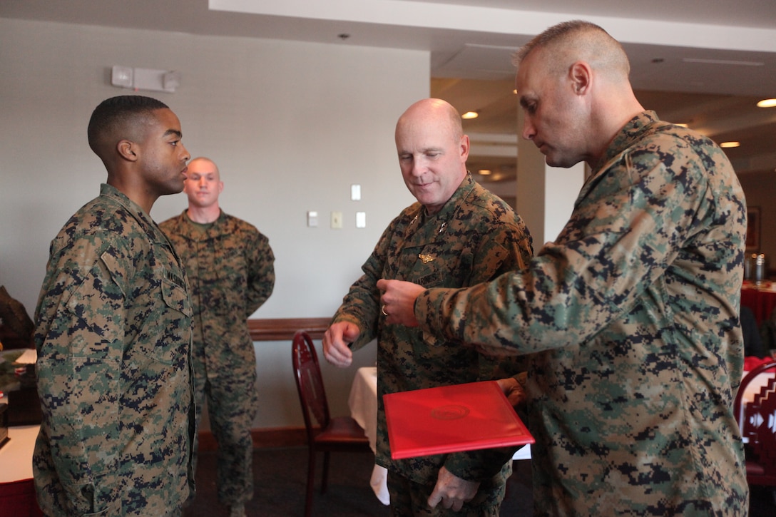 Maj. Gen. Carl B. Jensen, commanding general of Marine Corps Installations East, (center) and Sgt. Maj. Robert VanOostrom, sergeant major of MCIEAST (far right), present Sgt. Avery Washington II with the Navy and Marine Corps Achievement Medal during the MCIEAST breakfast and awards ceremony at the Ball Center aboard Marine Corps Base Camp Lejeune, Jan. 20. Washington, Cpl. Jesse Parke, and Petty Officer 1st Class Julian Esteban (not present), received the Navy and Marine Corps achievement medal and were recognized as the MCIEAST Marine, noncommissioned officer and sailor of the year for 2010.