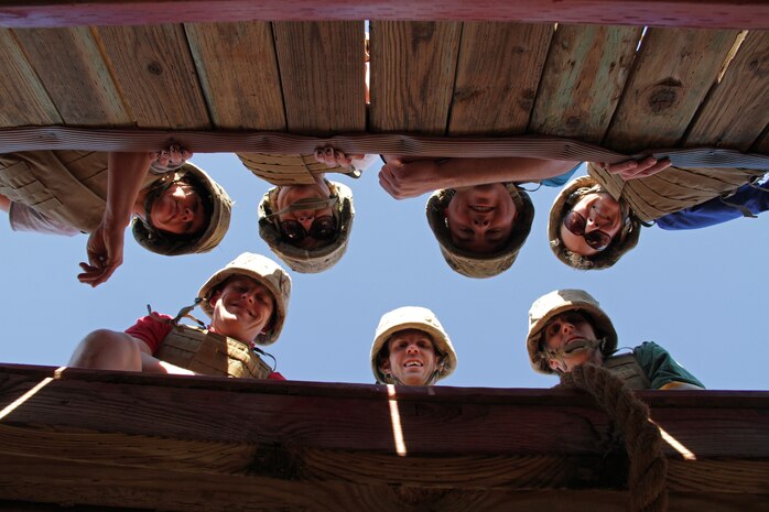 Teachers and school administrators peak over the top of an obstacle Jan. 20 during the 2011 Recruiting Station Twin Cities Educators' Workshop. The obstacle was one of several stations recruits must complete during the Crucible, a 54-hour training event conducted near the end of boot camp. Thirty-seven educators from Minnesota and North Dakota attended the workshop. For more photos of the event, visit the RS Twin Cities fan page at www.facebook.com/rstwincities.