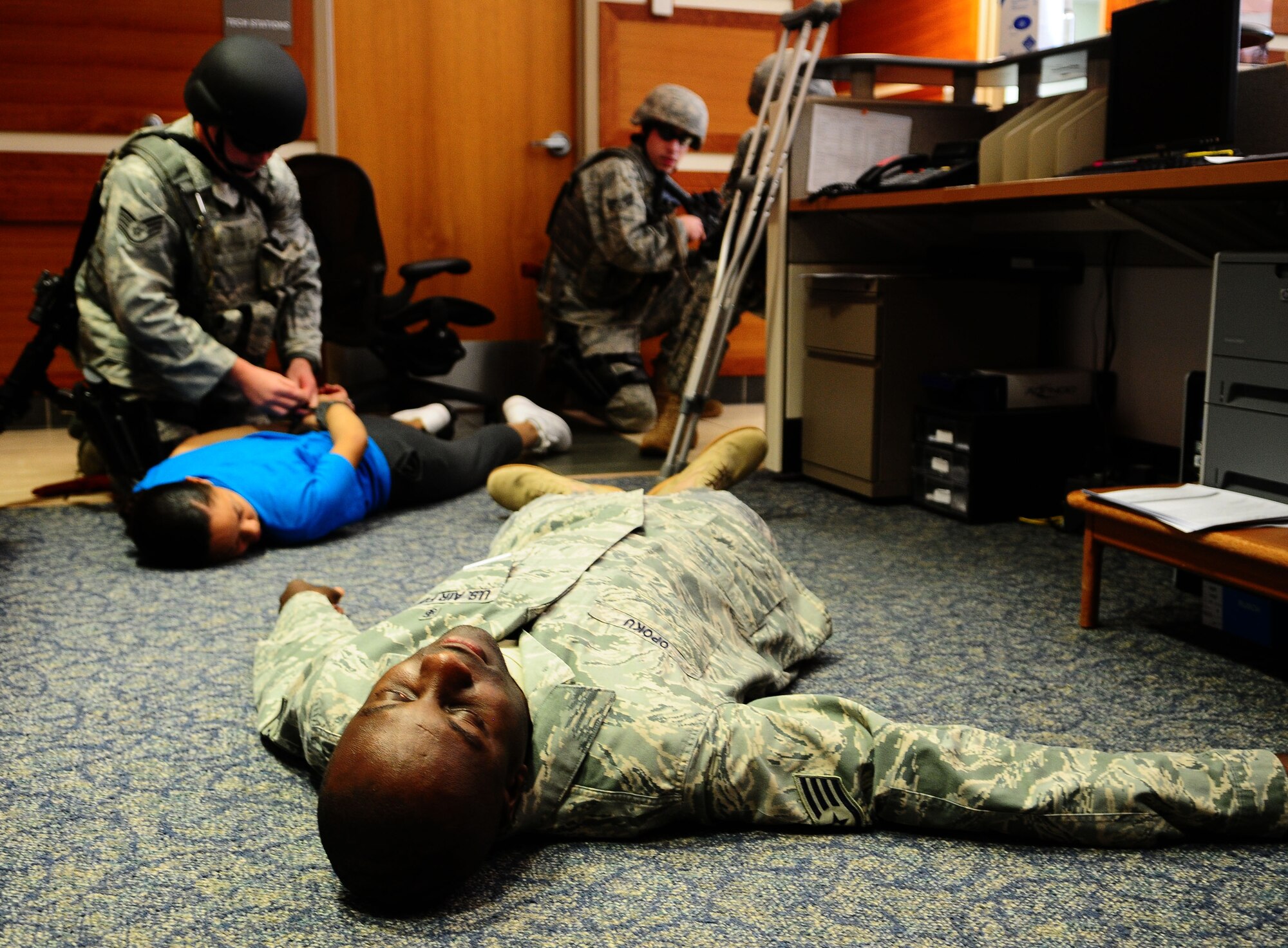 Airmen from the 36th Security Forces Squadron subdue an assailant and secure the 36th Medical Group building during an active shooter exercise at Andersen Air Force Base, Jan. 12. The exercise tested first responders as well as medical group personnel on their response in the event of an active shooter. (U.S. Air Force photo/Airman 1st Class Jeffrey Schultze) 