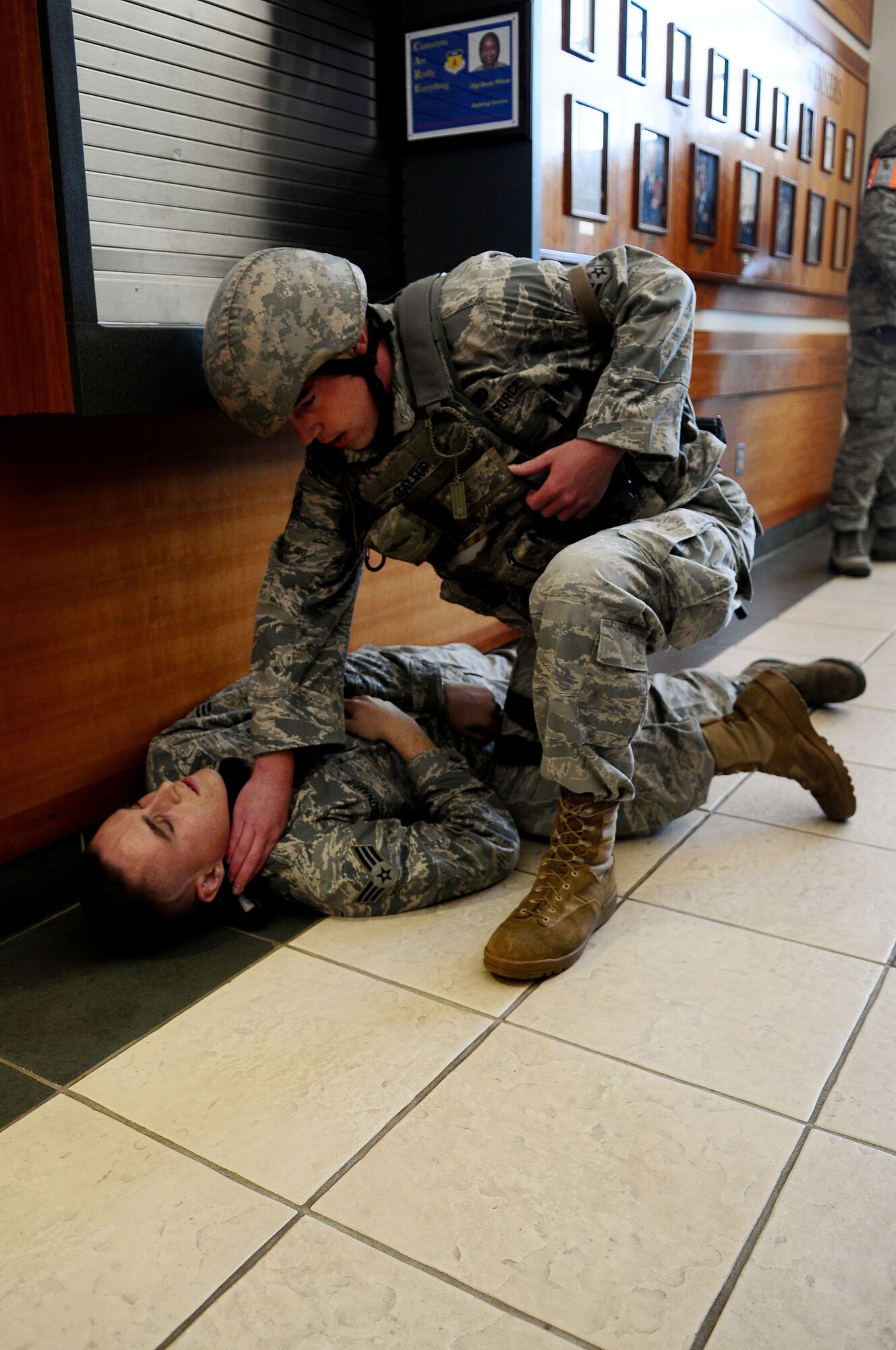 Senior Airman Christopher Gallup from the 36th Security Forces Squadron administers first aid to a role player during an active shooter exercise at Andersen Air Force Base, Jan. 12. The exercise tested first responders as well as medical group personnel on their response in the event of an active shooter. (U.S. Air Force photo/Airman 1st Class Jeffrey Schultze)