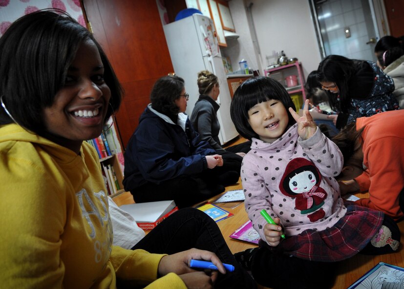 Airman 1st Class Shaquasia Dunn, 25th Fighter Squadron, Osan Air Base, plays with a child at the Cheonan orphanage during an visit by Osan Airmen, Jan. 15. The Osan base chapel organizes a monthly trip to local orphanages, where volunteers have the opportunity to play with and talk to the children. (U.S. Air Force photo by Senior Airman Evelyn Chavez) 