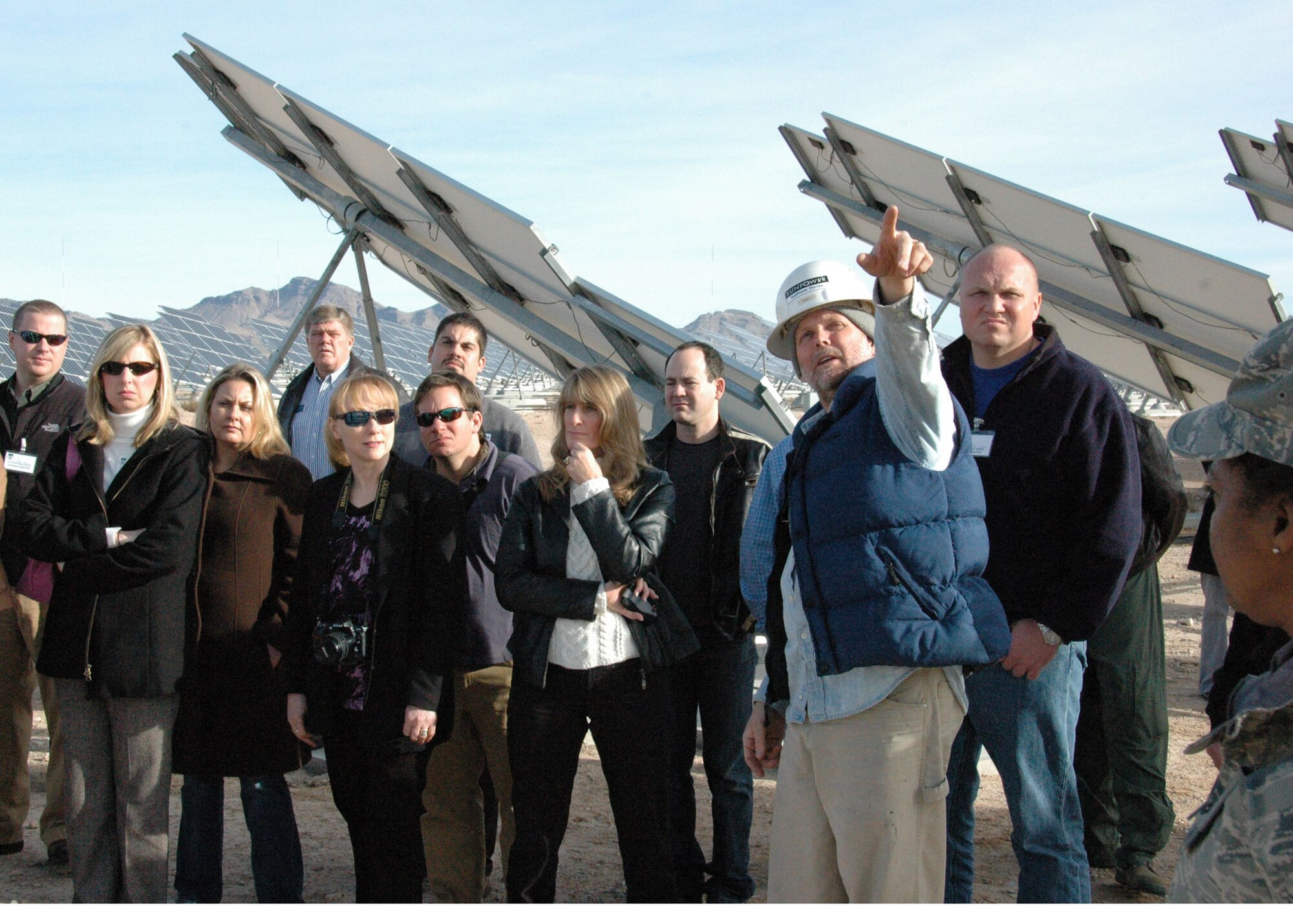 Contractor Eric Vanderleest briefs visiting civic leaders from the 919th Special Operations Wing, Duke Field, Fla., and  the 315th Airlift Wing, Joint Base Charleston, S.C., about the sprawling photovoltaic array at Nellis AFB, Nev., Jan 13.   Nellis AFB now receives most of its electricity from the environmentally friendly energy source.   Civic leader tours are an Air Force Reserve program designed to increase community leaders' awareness and understanding of reservists’ roles in national security by inviting them to witness their mission at various installations.   (U.S. Air Force photo/Dan Neely).