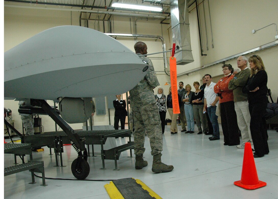 919th Special Operations Wing civic leaders listen to a briefing about the MQ-1 Predator remotely piloted aircraft Jan. 13 during a two-day civic leader tour of Nellis Air Force Base, Nev.,  The group joined their counterparts from the Air Force Reserve's 315th Airlift Wing, Joint Base Charleston, S.C.   Civic leader tours are an Air Force Reserve program designed to increase community leaders' awareness and understanding of reservists’ roles in national security by inviting them to witness their mission at various installations.   The group also received a mission briefing from the commander of the  Nellis-based 2nd Special Operations Squadron, a geographically separated unit of the 919th SOW that remotely operates the aircraft on combat air patrols for combatant commanders overseas.  (U.S. Air Force photo/Dan Neely)