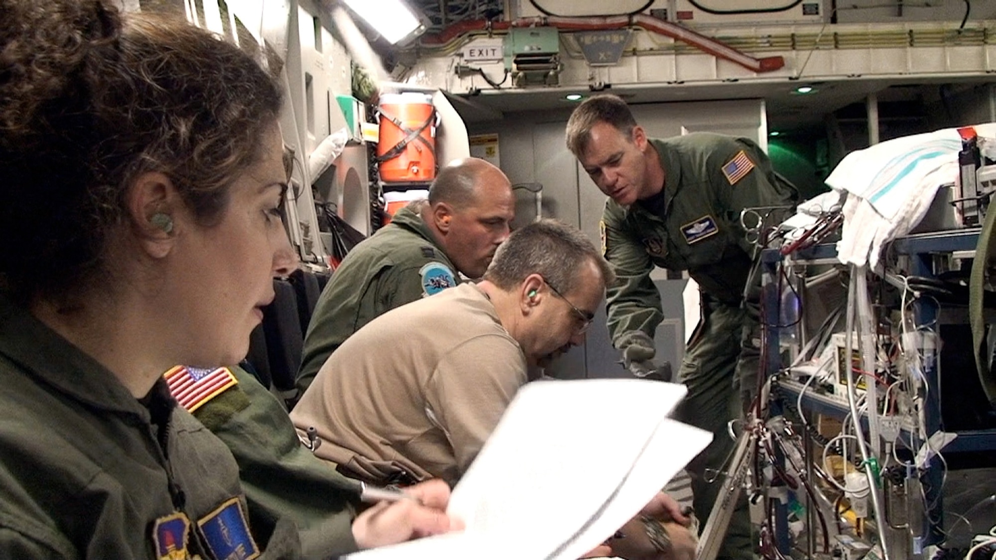 An extra corporeal membrane oxygenation team from Lackland Air Force Base, Texas,  cares for a critically ill infant on-board a C-17 Globemaster III en route to California, July 2010.  The ECMO team include (left to right): Maj. (Dr.) Melissa Tyree, 59th Maternal/Child Care Squadron; George Brandon, pediatric intensive care unit nurse; Capt. Terry Bailey, nurse, 59th Medical Inpatient Squadron; and Master Sgt. Thomas Kamin, 349th Aeromedical Evacuation Squadron, Air Force Reserve. (U.S. Air Force Photo/ Maj. Kreangkai Tyree)