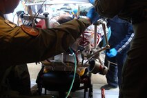 A civilian patient being moved onto a Gulfstream III jet on the special Extracorporeal Membrane Oxygenation stretcher that her joint-service/military-civilian medical team constructed from scratch in November 2010. This, the longest adult ECMO transport ever recorded, took approximately 12 hours from the patient’s Hawaii hospital bed to her Iowa hospital bed. (Courtesy photo)