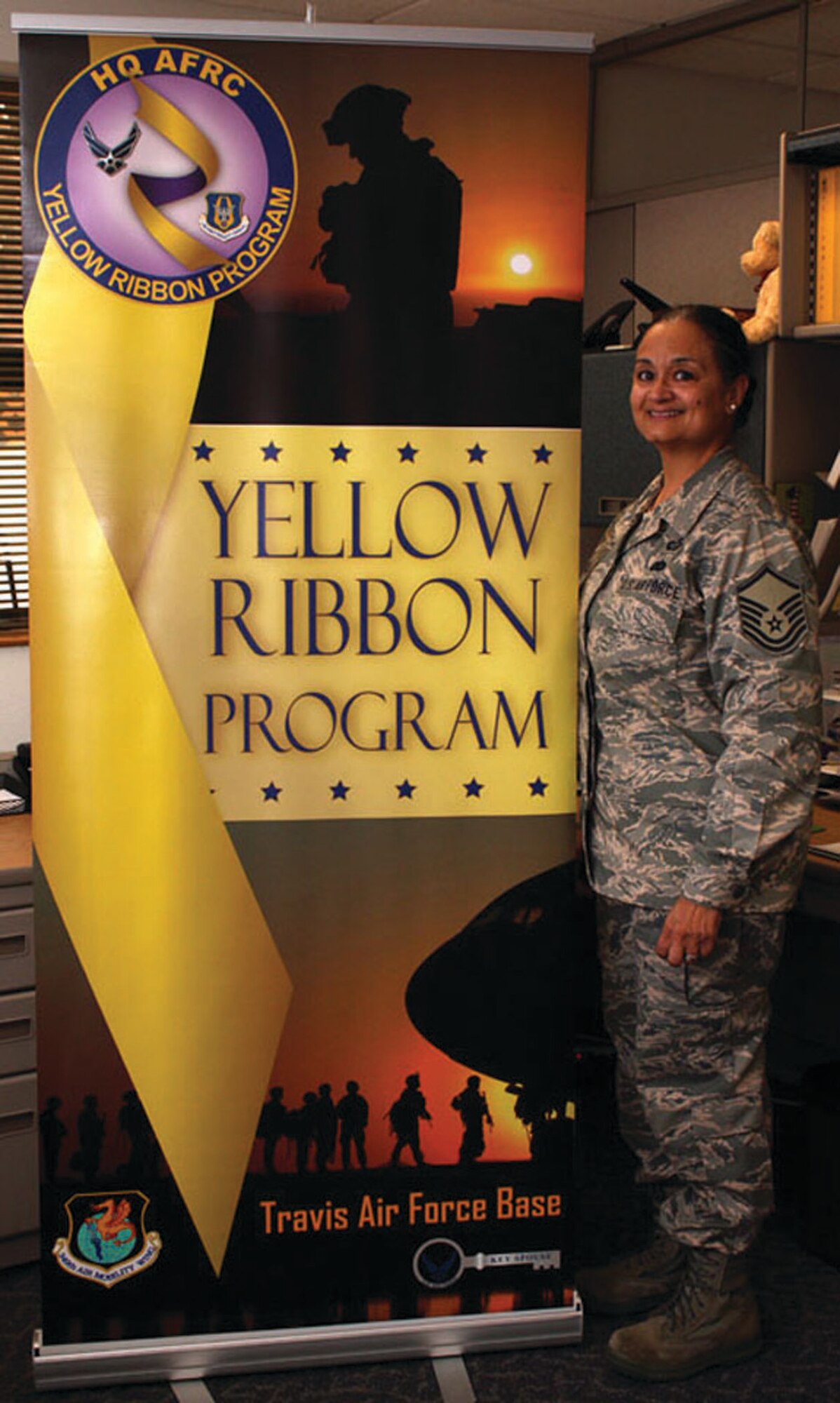 TRAVIS AIR FORCE BASE, Calif. -- Master Sgt. Pamela Silas, Yellow Ribbon Program Coordinator, 349th Air Mobility Wing, is pictured here with a Yellow Ribbon banner in her office recently. (U.S. Air Force photo/Senior Airman Amelia Leonard) 