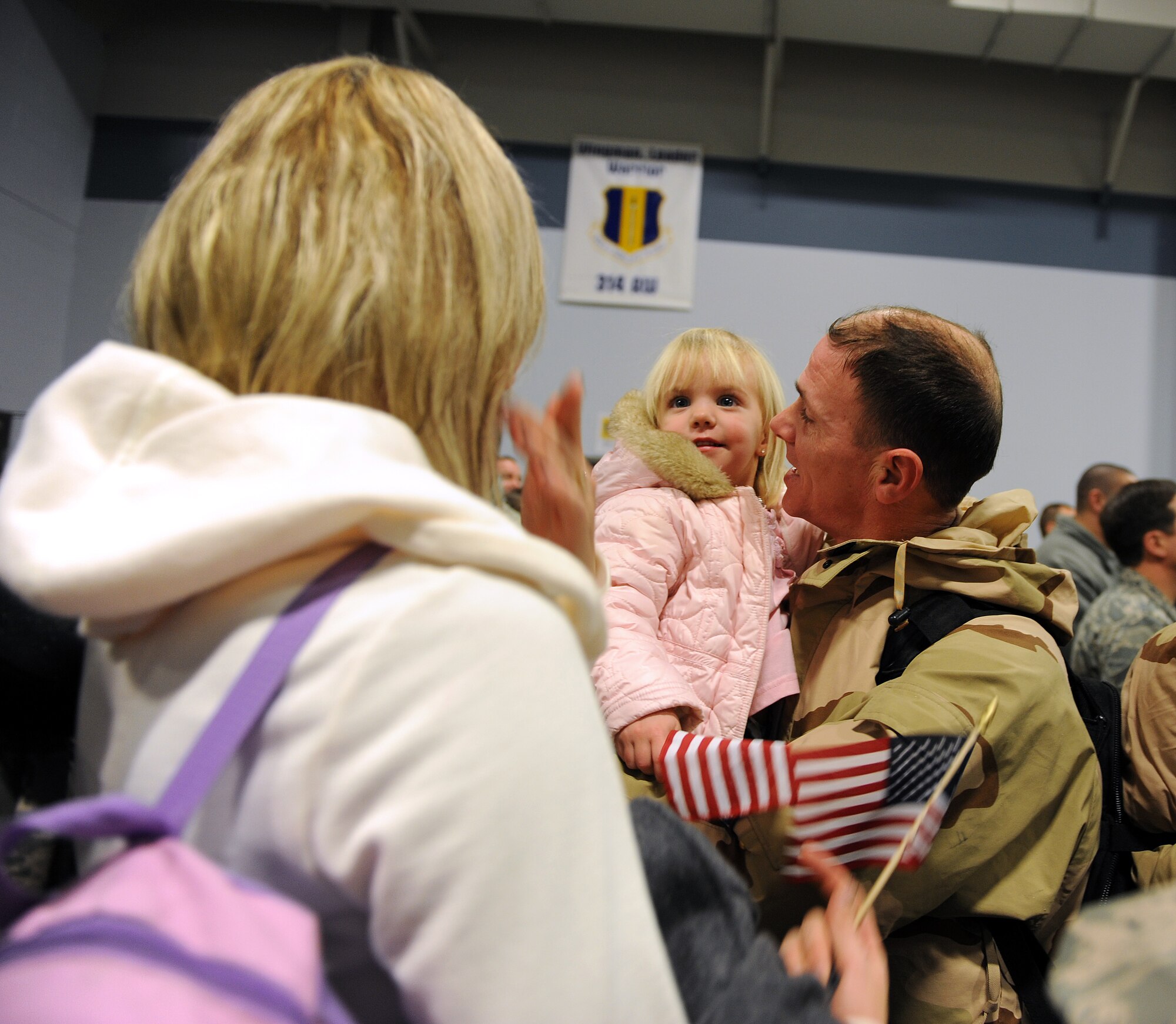 Master Sgt. Randall Ransburgh, a 53rd Airlift Squadron loadmaster, is greeted by his wife, Labrina; and his daughter, Reese; Jan. 20, 2011, at the 19th Logistics Readiness Squadron passenger terminal at Little Rock Air Force Base, Ark. Snow and wintery weather didn’t stop the Airmen from reuniting with their families. (Air Force photo by Airman 1st Class Ellora Stewart)
