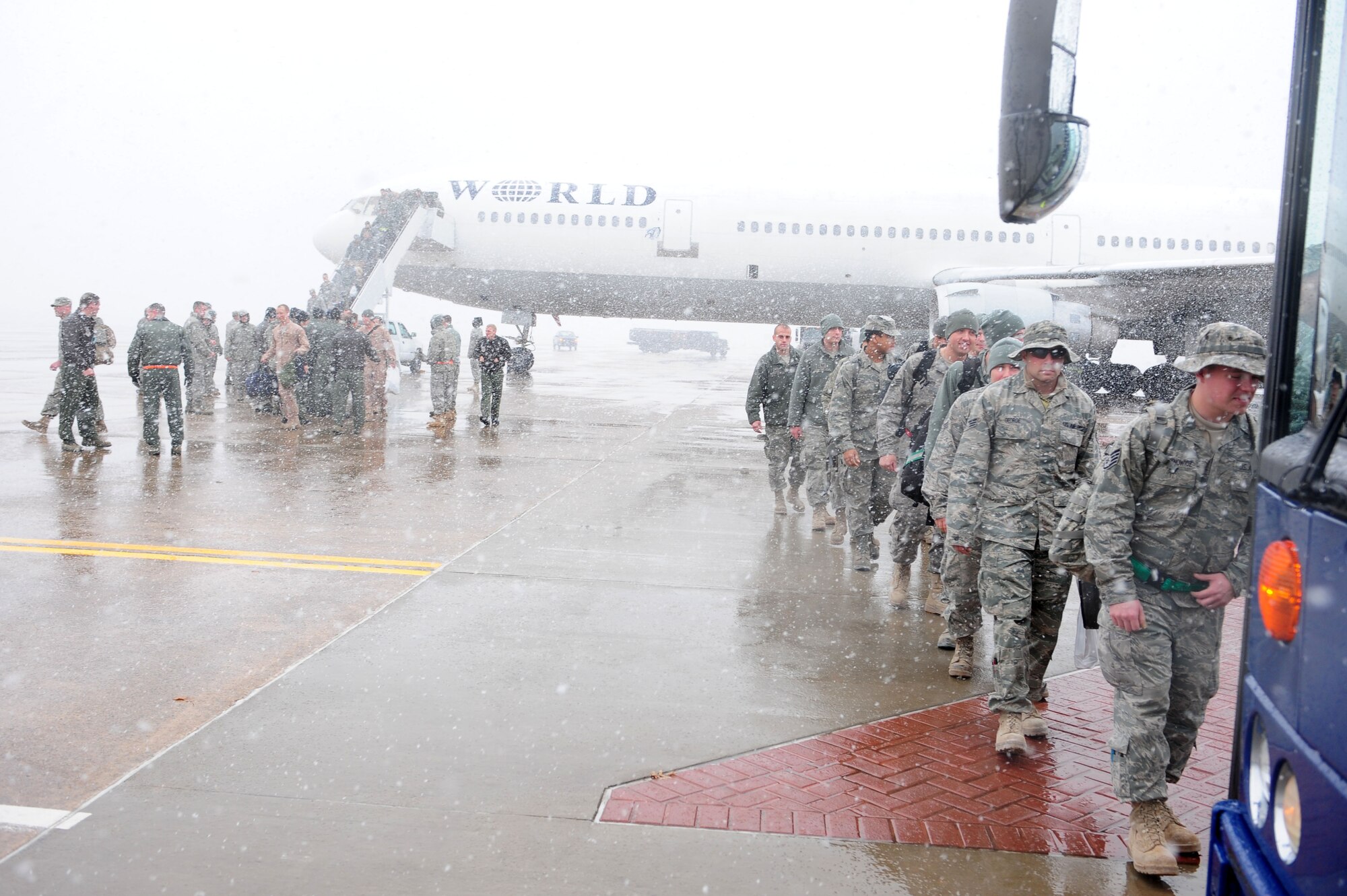 Team Little Rock members board a bus Jan. 20, 2011, after returning home from deployment at Little Rock Air Force Base, Ark. The Airmen returned from various deployed locations, such as Afghanistan, Iraq and Kuwait. (U.S. Air Force photo by Senior Airman Jim Araos)