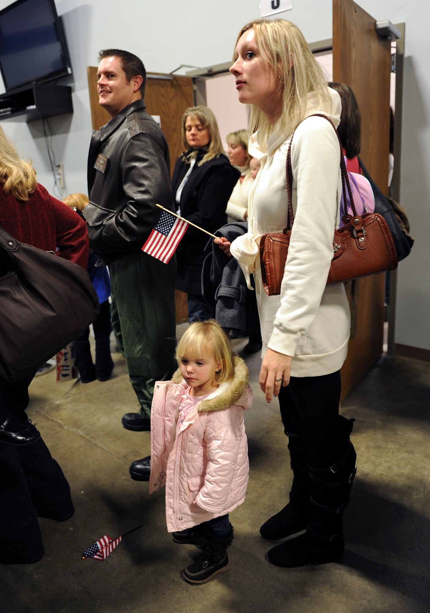 Master Sgt. Randall Ransburgh’s wife, Labrina; and daughter, Reese; wait for his arrival home Jan. 20, 2011, at the 19th Logistics Readiness Squadron passenger terminal at Little Rock Air Force Base, Ark. Sergeant Ransburgh, a 53rd Airlift Squadron loadmaster, along with more than 200 Airmen arrived home after their tour in Southwest Asia. (Air Force photo by Airman 1st Class Ellora Stewart)