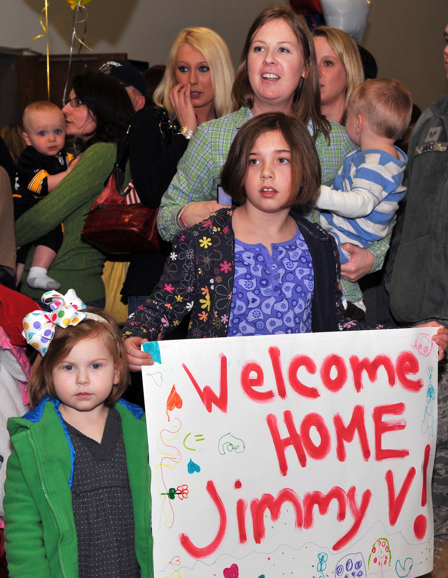 Master Sgt. James  Vehlies’ wife, Jodi; daughters, Carl, 11; Averi, 4; and son Eliot, 1; await his return home  Jan. 20, 2011, at Little Rock Air Force Base, Ark.  Sergeant Vehlies, 19th Aircraft Maintenance Squadron, returned home with more than 200 Airmen from overseas. (U.S. Air Force photo by Senior Airman Gul Crockett)