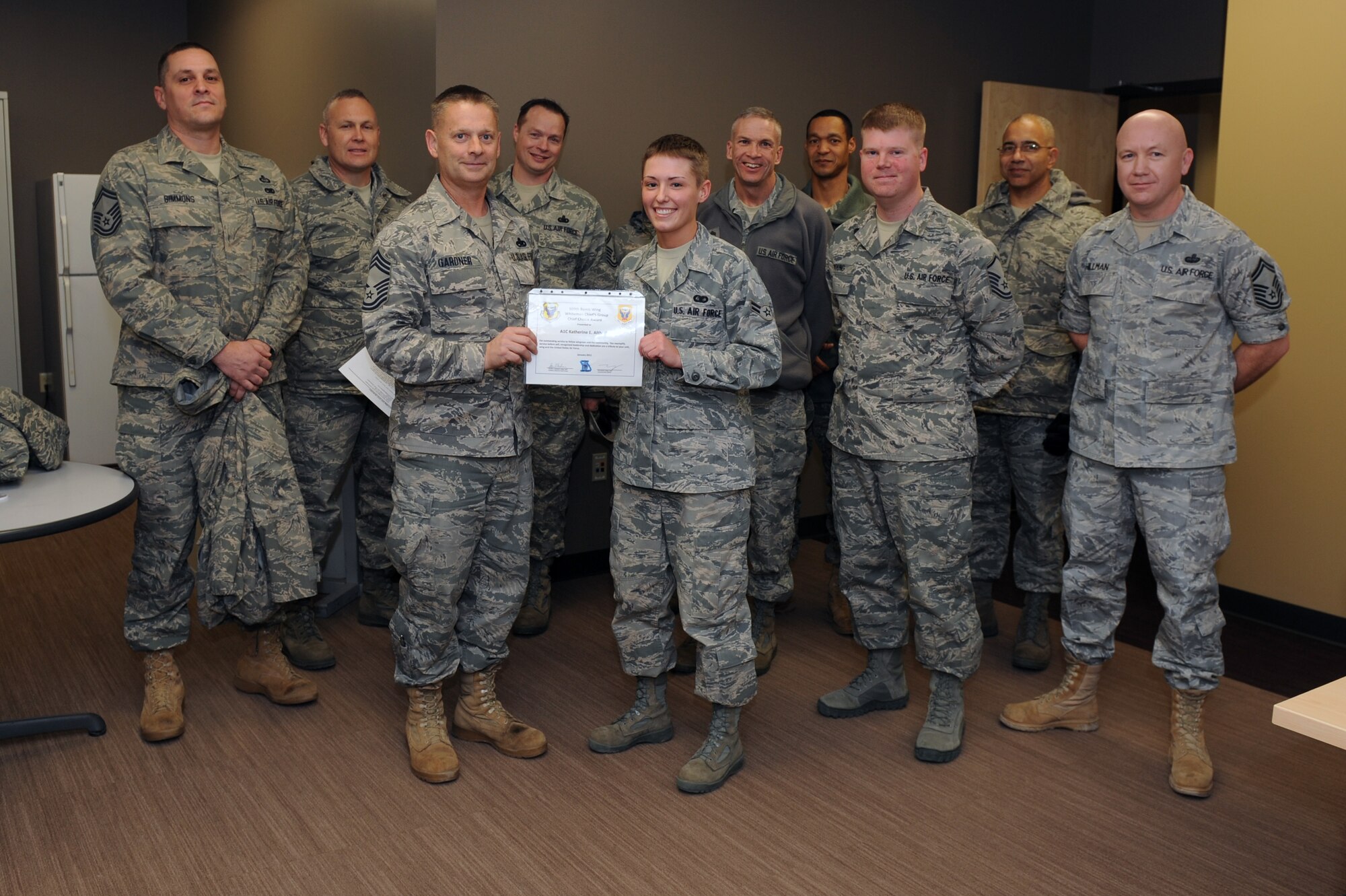 WHITEMAN AIR FORCE BASE, Mo., -- Chief Master Sgt. Steven Gardner and the Whiteman Chiefs Group present the Chief's Choice Award to Airman 1st Class Katherine Althoff Jan. 19. (U.S. Air Force photo/Staff Sgt. Jason Huddleston) (Released)
