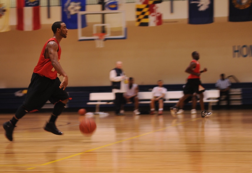 MOODY AIR FORCE BASE, Ga. -- Derrick Finch-Mackie dribbles the ball down the court during the last few minutes of an intramural basketball game Jan. 19. The 822nd Base Defense Squadron led the entire game in points and won the game against the 23rd Component Maintenance Squadron 50-35. (U.S. Air Force photo/Airman 1st Class Douglas Ellis)(RELEASED)

