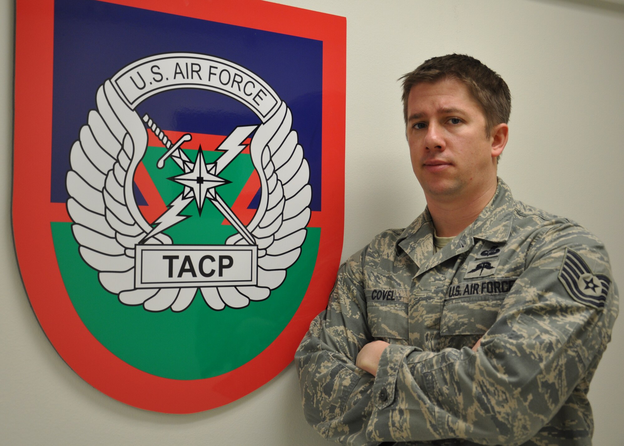 Tech. Sgt. Earl Covel, 720th Special Tactics Group Tactical Air Control Party member, poses in front of his unit's patch at Hurlburt Field, Fla, Jan. 20, 2011. Sergeant Covel was selected for this week's "Tip of the Spear" spotlight. (DoD photo by U.S. Air Force Staff Sgt. Sarah Martinez/RELEASED)