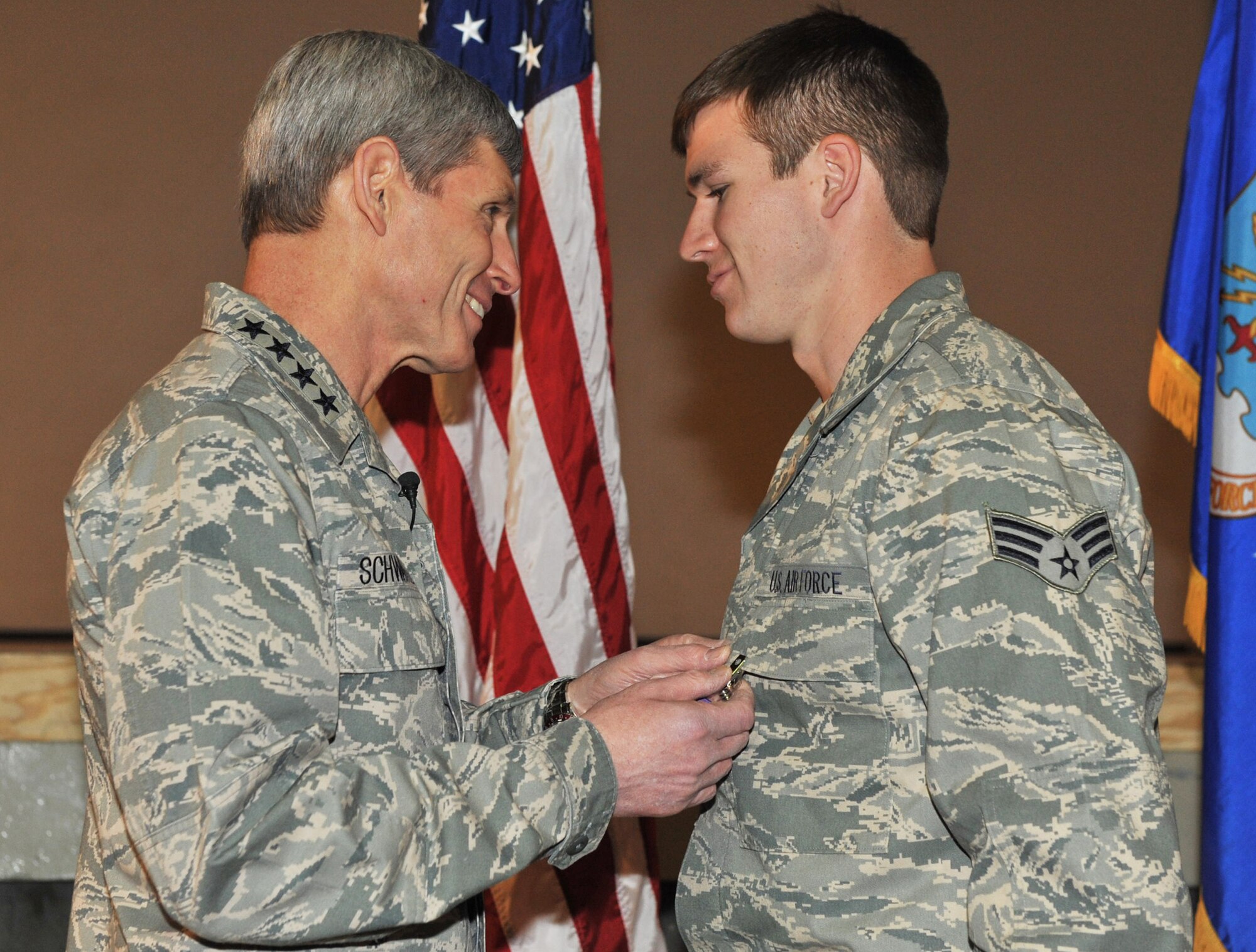 Air Force Chief of Staff Gen. Norton Schwartz pins a Purple Heart medal on Senior Airman Brandon Cullen Towle, a joint terminal attack controller assigned to the 817th Expeditionary Air Support Operations Squadron, during a ceremony at Bagram Airfield, Afghanistan, on Jan. 19, 2011.  (U.S. Air Force photo/Senior Airman Shelia deVera)