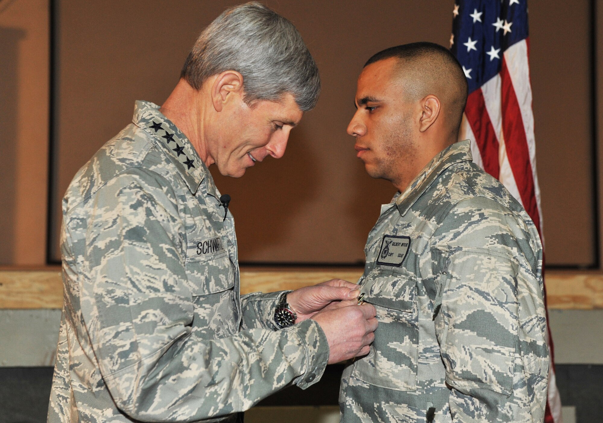 Air Force Chief of Staff Gen. Norton Schwartz pins a Purple Heart medal on Capt. Gil Wyche, a security forces officer assigned to the 966th Air Expeditionary Squadron, during a ceremony at Bagram Airfield, Afghanistan, on Jan. 19, 2011. (U.S. Air Force photo/Senior Airman Shelia deVera)