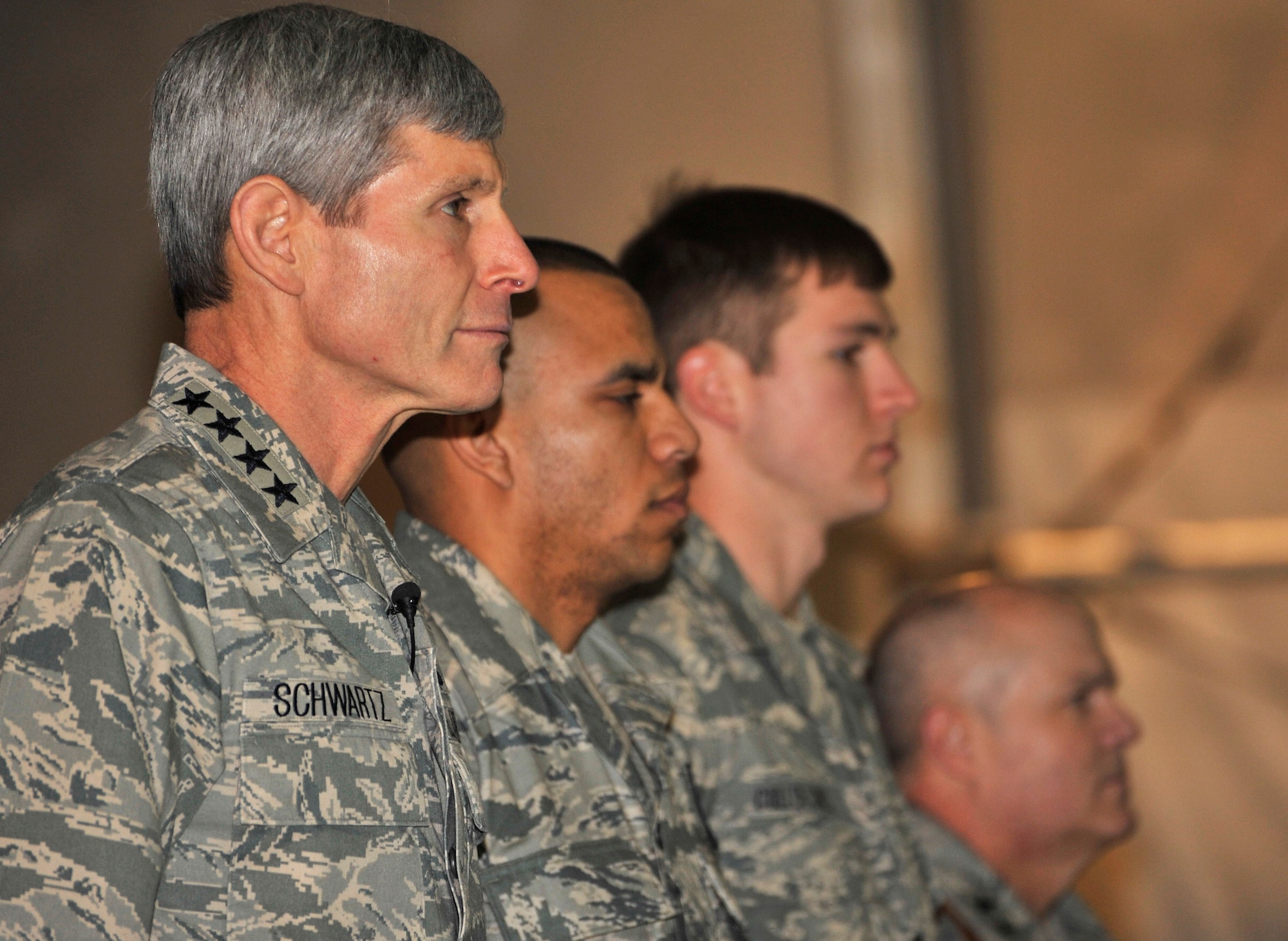 (From left) Gen. Norton Schwartz, Air Force chief of staff; Capt. Gil Wyche, a security forces officer assigned to the 966th Air Expeditionary Squadron; Senior Airman Brandon Cullen Towle, a joint terminal attack controller assigned to the 817th Expeditionary Air Support Operations Squadron; and Maj. Gen. Charles W. Lyon, 9th Air and Space Expeditionary Task Force-Afghanistan commander, stand at attention during a Purple Heart presentation ceremony at Bagram Airfield, Afghanistan, on Jan. 19, 2011.  General Schwartz presented Captain Wyche and Airman Cullen Towle with Purple Hearts during the ceremony. (U.S. Air Force photo/Capt. Erick Saks)