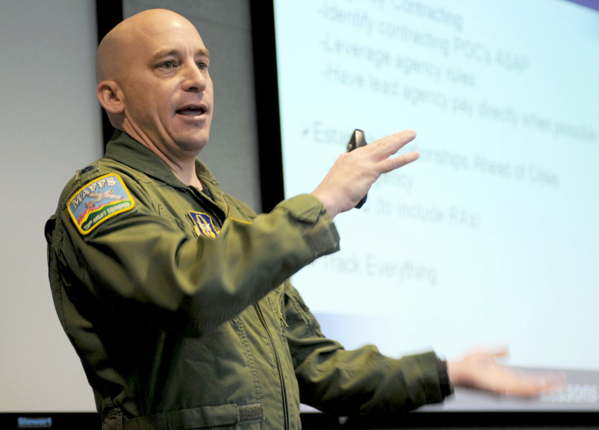 Lt. Col. David Condit briefs Airmen attending the first Air Force Reserve Command C-130 Special Mission Conference Jan. 12-13, 2011, at Peterson Air Force Base, Colo. The conference was designed to share lessons learned, review policies and procedures, and tackle common support issues involved with the weather reconnaissance, aerial spray and aerial firefighting missions. Colonel Condit is the 302nd Airlift Wing chief of safety and director of the 302nd AW's aerial firefighting program. (U.S. Air Force photo/Capt. Marnee A.C. Losurdo) 
