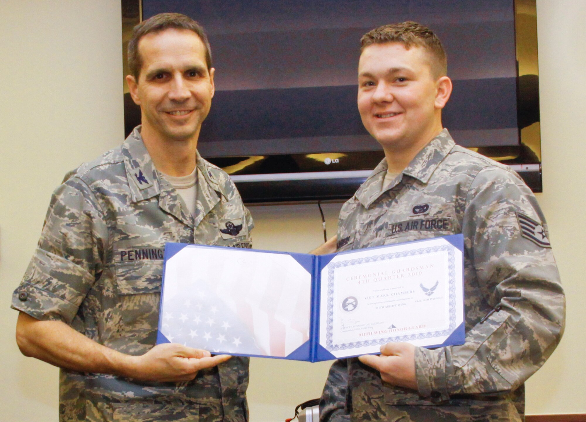 Col. Jeffrey T. Pennington, left, 911th Airlift Wing commander, presents the Ceremonial Guardsmen of the Quarter (fourth quarter) to Staff Sgt. Mark Chambers, 32nd Aerial Port Squadron. Sergeant Chambers was one of seven members of the Honor Guard to receive a quarterly award during the guard’s awards banquet Jan. 8. (Photo by Tech. Sgt. Scott Pryor/USAFR)