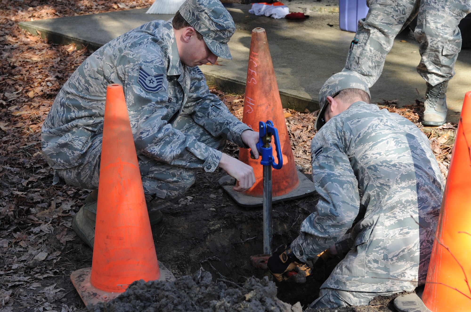 SEYMOUR JOHNSON AIR FORCE BASE, N.C. – Technical Sgt. Anthony Fletcher (left) and Airman 1st Class Morgan Lane repair a yard spigot in the Family Camp here Jan 19, 2011. The purpose of the repair was to increase the water pressure of one of the hoses used to supply water to the area and ensure the spigot was free of debris. Both Airmen are from 4th Civil Engineer Squadron water and fuels system maintenance flight with the 4th Civil Engineer Squadron. Recently, the 4th CES was recognized as the best large civil engineer squadron in the Air Force. Sergeant Fletcher is a native of Tuppalo, Miss., and Airman Lane hails from Dallas. (U.S. Air Force photo/Senior Airman Marissa Tucker)