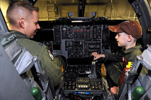 Capt. Chris Williams, 34th Bomb Squadron pilot, shows Aric Lassegard the flight controls aboard a B-1B Lancer at Ellsworth Air Force Base, S.D., Jan. 13, 2011.  Aric was treated as an honorary member of the 34th BS as part of the Aircrew for a Day program. (U.S. Air Force photo/Staff Sgt. Marc I. Lane)