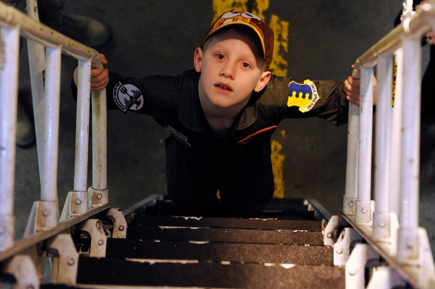 Aric Lassegard, 34th Bomb Squadron honorary aircrew, ascends the ladder of a B-1B Lancer at Ellsworth Air Force Base, S.D., Jan. 13, 2011.  The 34th BS gave Aric a tour of the squadron, a B-1B Lancer and several other base facilities as part of the Aircrew for a Day program. (U.S. Air Force photo/Staff Sgt. Marc I. Lane)