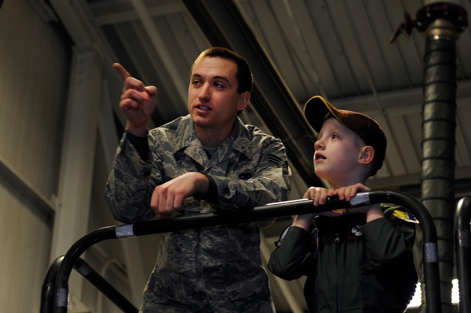 Senior Airman Brian Decker, 28th Aircraft Maintenance Squadron crew chief, describes the engine capabilities of the B-1B Lancer to Aric Lassegard, 34th Bomb Squadron honorary aircrew, at Ellsworth Air Force Base, S.D., Jan. 13, 2011.  Each of the four engines on the B-1 is capable of producing 30,000 pounds of thrust. (U.S. Air Force photo/Staff Sgt. Marc I. Lane)