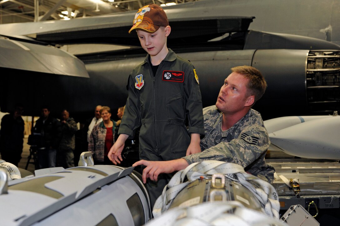 Staff Sgt. Bradley Allen, 28th Munitions Squadron assembled munitions manager, describes various munitions the B-1B Lancer can carry to Aric Lassegard at Ellsworth Air Force Base, S.D., Jan. 13, 2011.  Aric was an honorary member of the 34th BS as part of the Aircrew for a Day program. (U.S. Air Force photo/Staff Sgt. Marc I. Lane)