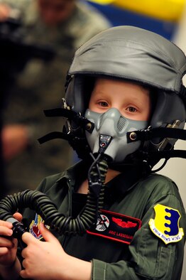 Aric Lassegard, 34th Bomb Squadron honorary aircrew, wears a HGU-55/P aircrew helmet with the MBU-12/P oxygen mask attached at Ellsworth Air Force Base, S.D., Jan. 13, 2011.  Aric was treated as an honorary member of the 34th Bomb Squadron as part of the Aircrew for a Day program. (U.S. Air Force photo/Staff Sgt. Marc I. Lane)