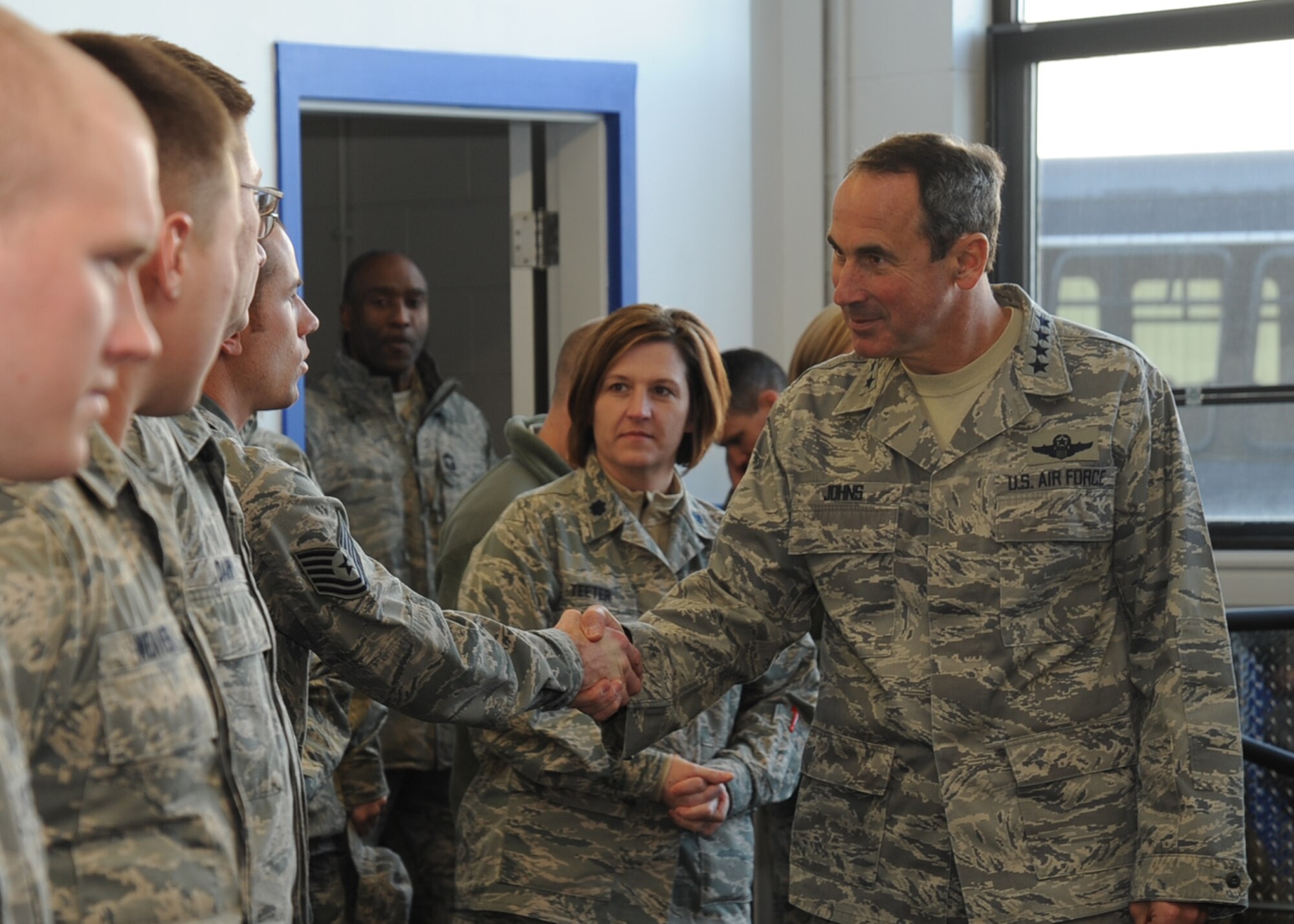 Gen. Raymond Johns Jr., Air Mobility Command commander greets Airmen at the flightline fitness center in the maintenance complex, Jan. 11, 2011, McConnell Air Force Base, Kan.  During General Johns’ visit to McConnell he spoke to Airmen and presented the 22nd Air Refueling Wing with the Meritorious Unit Award. (U.S. Air Force photo/Staff Sgt. Dallas Edwards)