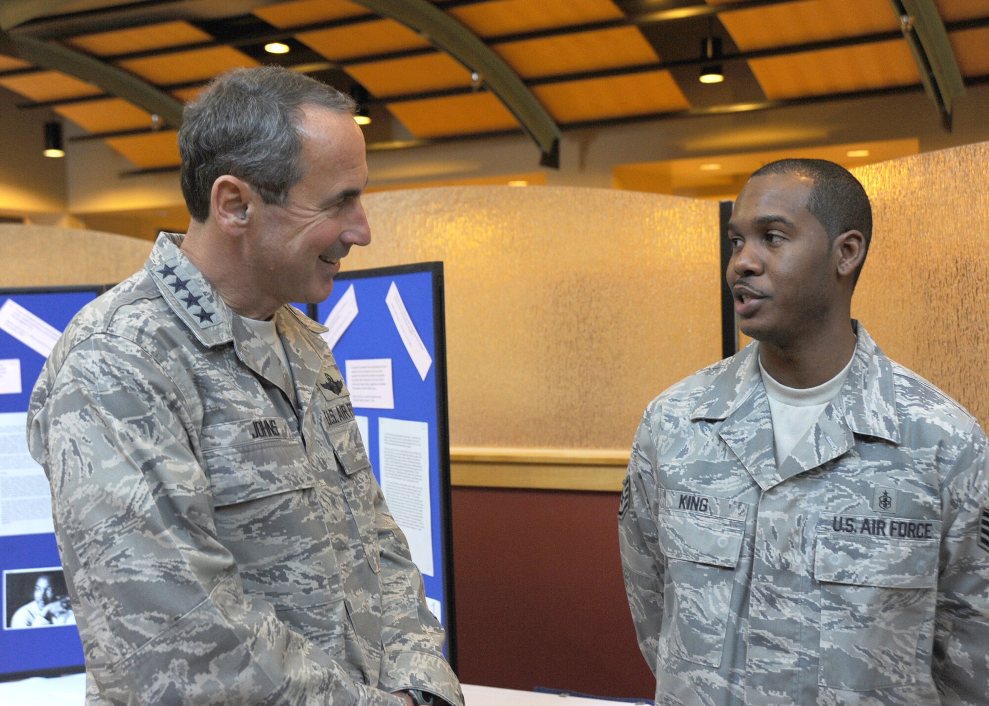 Gen. Raymond Johns Jr., Air Mobility Command commander, talks to Staff Sgt. Julius King Jr., 22nd Medical Support Squadron, NCOIC of pharmacy support, at the Robert J. Dole Community Center, Jan. 11, 2011, McConnell AFB, Kan. General Johns, along with Chief Master Sgt. David Spector, Air Mobility Command command chief master sergeant, visited McConnell’s four refueling squadrons, toured the fitness center and the maintenance complex. (U.S. Air Force photo/Staff Sgt. Dallas Edwards)