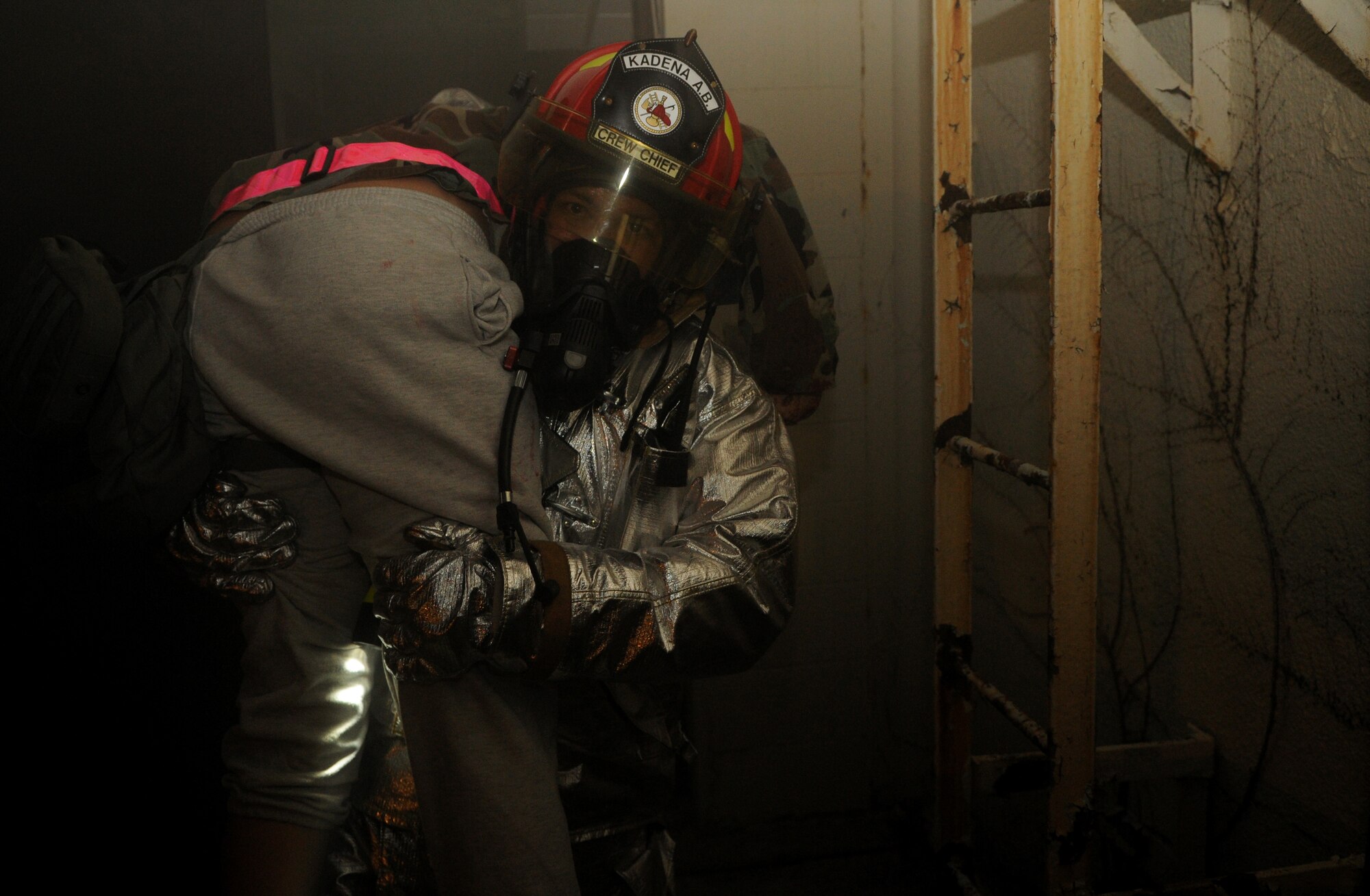 A fireman from the 18th Civil Engineer Squadron extracts a “victim” from a simulated burning building during Beverly High 11-02, a local operational readiness exercise at Kadena Air Base, Japan, Jan. 20. Kadena's emergency response units use exercises such as this to train for real-world emergencies. (U.S. Air Force photo/Airman 1st Class Jarvie Z. Wallace)